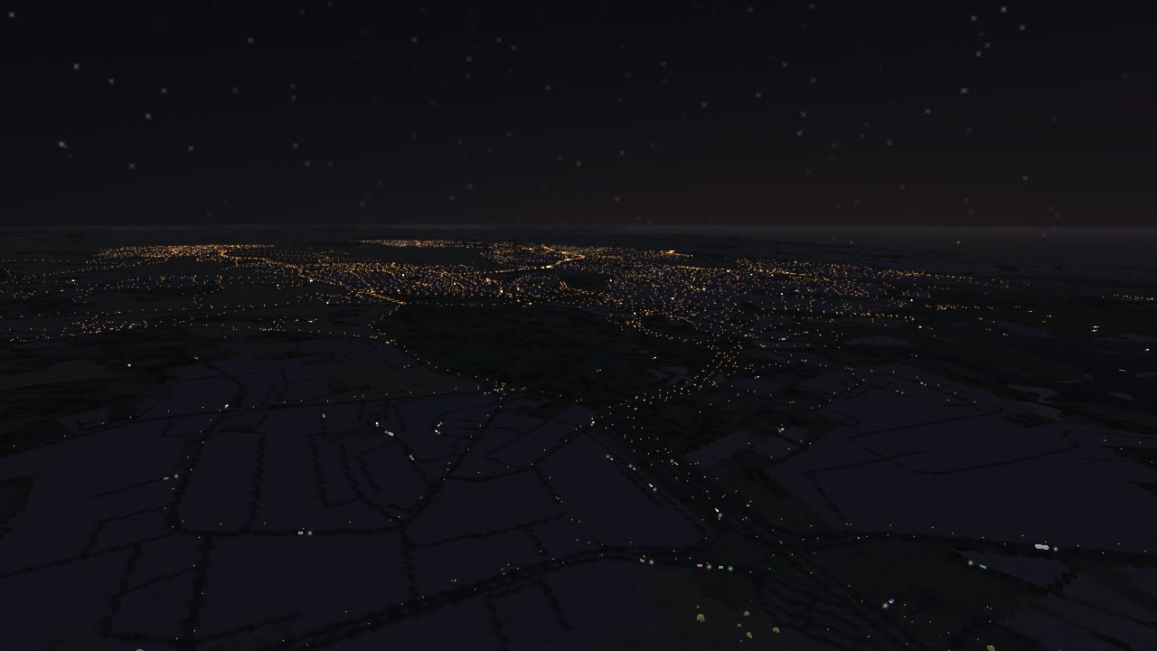 A town at night, streets picked out in orange lighting